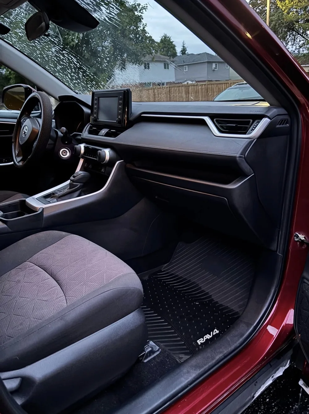 Toyota RAV4 interior after detailing, with a clean floor mat and dashboard