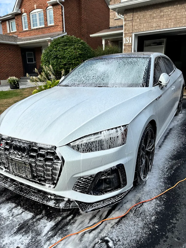 Foam pre-soak on a sedan before the hand wash begins